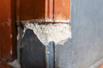 damage to the wall of the house near the door frame. due to lack of maintenance.