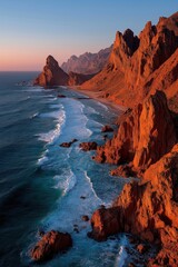 Orange cliffs framing a long beach at sunset