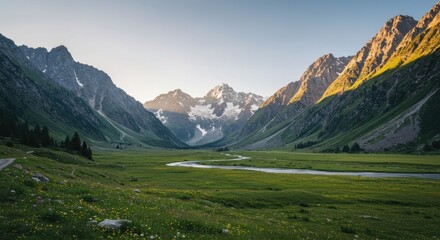 Naklejka premium A serene valley stretches between towering, snow-capped mountains, bathed in the soft light of a sunrise or sunset.