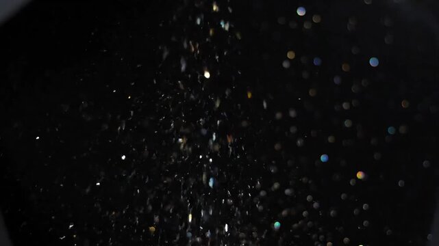 Magical sparkling dust particles floating in dark space, creating a sense of wonder and mystery.