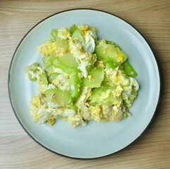 Top view of high fiber Thai vegetarian stir-fry angled luffa and egg. Excellent for digestion and weight management, a light wholesome Asian dish.