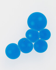 Minimalistic macro photo of vivid blue oil drops floating on water surface. Cosmetic texture representing hydration, active ingredients, serum, skincare science or hyaluronic acid.