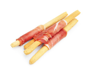 Delicious grissini sticks with prosciutto isolated on white