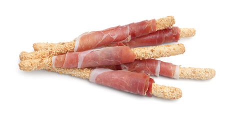 Delicious grissini sticks with sesame seeds and prosciutto isolated on white