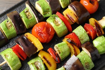 Vegetarian barbecue. Skewers with tasty grilled vegetables on table, above view