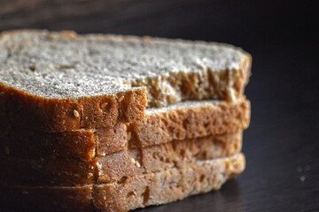 Brown Bread Slice Detail. Close-up detail of sliced brown bread with textured crust.
