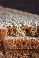 Fresh Bread Slice Macro Close-Up. Vertical close-up of fresh bread slice with detailed crust and texture.