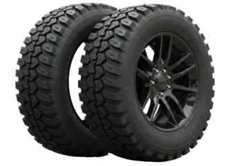 Isolated two rugged off-road tires with aggressive tread pattern and black alloy wheels ready for adventure and extreme terrain driving