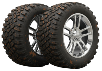 Isolated pair of rugged off road vehicle tires with chrome rims covered in mud and dirt ready for extreme terrain adventures