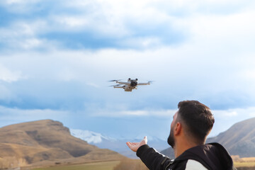 Drone flying in the sky over the mountains. The concept of remote control.