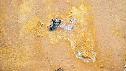 Yellow wall with peeling paint texture