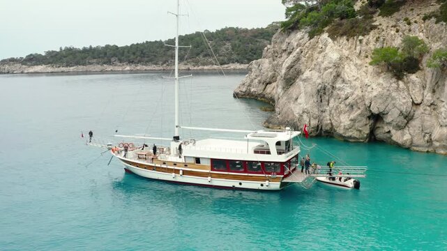 Sailing to hidden coves in clear blue waters surrounded by rocky cliffs