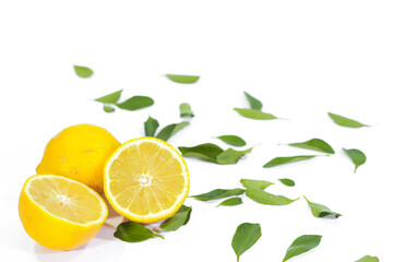 Whole and Halved Lemons with Leaves on a White Background