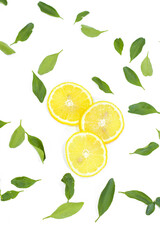 Top View of Sliced Lemons and Leaves on a White Background