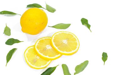 Whole and Sliced Lemons with Leaves on a White Background