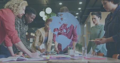 Six team members leaning over table activating 3D globe overlay marking maps for business planning - Powered by Adobe