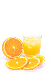 Glass of Valencia Orange Juice with a Whole and Sliced Oranges on a White Background