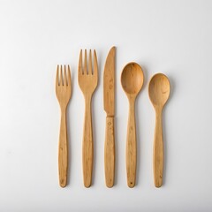 A set of bamboo cutlery neatly lined up on a white background. A minimalistic set of eco-friendly products.