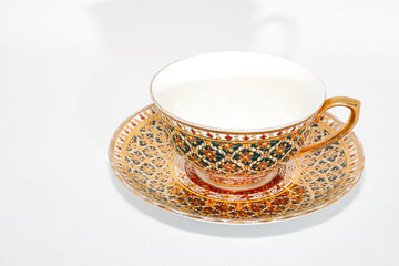 Antique thai ceramics porcelain, benjarong teacup and saucer isolated on white background.