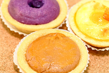 vareity of bake hokkaido cheese tart on the wooden background.