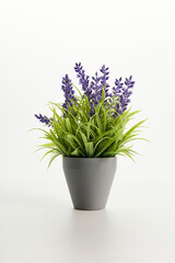 artificial lavender in a grey pot on a light background