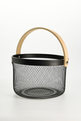 an iron basket with wooden handles on a white background
