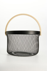 an iron basket with wooden handles on a white background