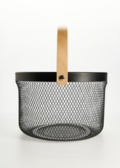 an iron basket with wooden handles on a white background