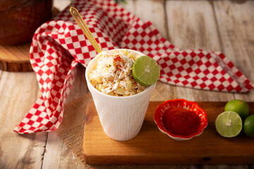 Esquites. Corn kernels cooked and served with mayo, sour cream, lemon and chili powder, very popular street food in Mexico, also known as Elote en Vaso. The recipe varies depending on the region.