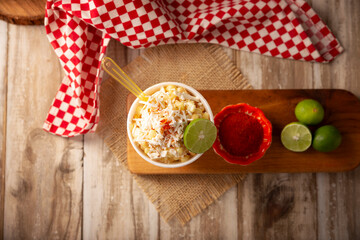 Esquites. Corn kernels cooked and served with mayo, sour cream, lemon and chili powder, very popular street food in Mexico, also known as Elote en Vaso. The recipe varies depending on the region.
