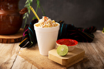 Esquites. Corn kernels cooked and served with mayo, sour cream, lemon and chili powder, very popular street food in Mexico, also known as Elote en Vaso. The recipe varies depending on the region.