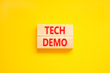 Tech demo symbol. Concept word Tech demo on beautiful wooden blocks. Beautiful yellow paper background. Business tech demo concept. Copy space.