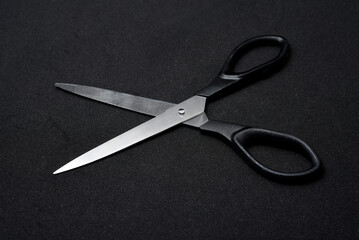 Two scissors on a black background. Stationery scissors.