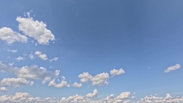 Incredibly beautiful grey cumulus textured clouds under blue sky on partly cloudy day. Timelapse mode.