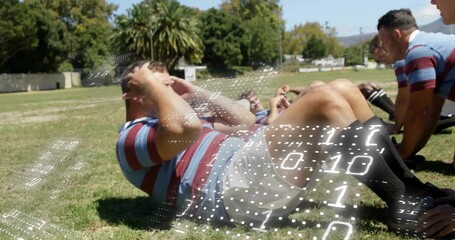 rugby players bringing hands to temples and performing sit-ups on grassy field for team fitness