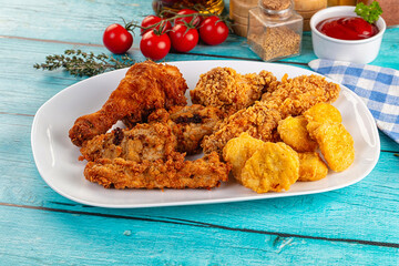 Golden crispy fried chicken mix - wings, drumsticks, nuggets and strips