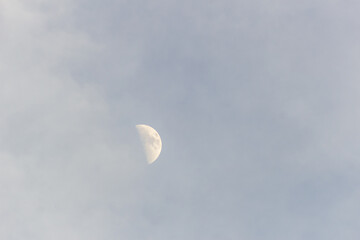 Moon in the blue sky with white clouds, 
