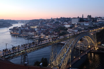 Obraz premium The twilight view of Dom Luís I Bridge aka Luiz I Bridge over Douro River with historic center of Porto in the background.Porto.Portugal