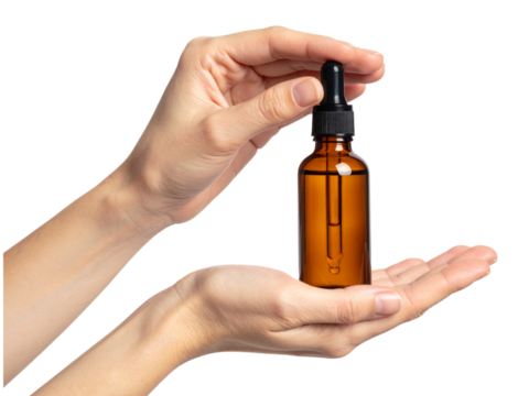 Female hands holding brown bottle with essential oil isolated on transparent background