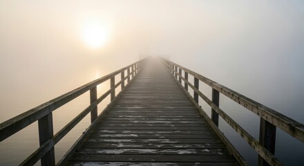 Obraz premium Wooden pier stretching into a foggy, misty lake at sunrise