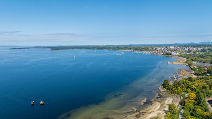 Aerial view of Burlington, Vermont with Lake Champlain's blue waters and marina stretching into the distance.