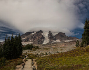 Hikers on Mazama Ridge trail hiking toward Mount Rainier