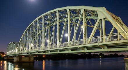 Fototapeta premium Illuminated bridge spans across the water under a starry night sky