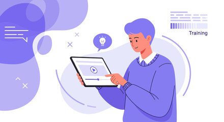 A young man learns to use a tablet for online training, webinars and courses while on the go for