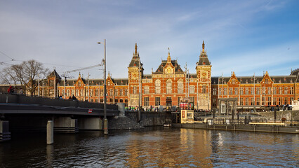 Amsterdam, Netherlands; February-24, 2025: View of the beautiful facade of Amsterdam Central Station (Netherlands) at sunset