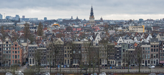 Amsterdam, Netherlands; February-24, 2025: View of the beautiful facade of Amsterdam Central Station (Netherlands) at sunset