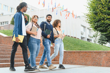 Fototapeta premium Diverse students walking on university campus together