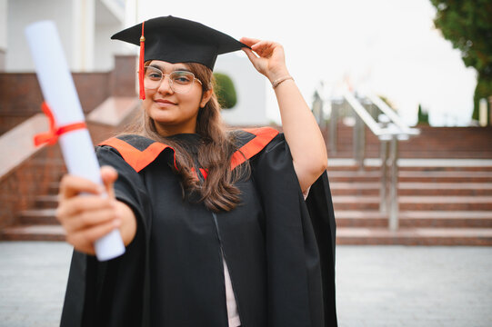 Indian university student celebrating graduation holding diploma