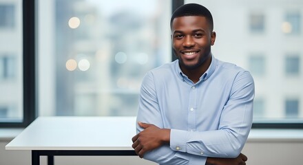 Naklejka premium Young Black Man Working on Laptop in Modern Office, Focused and Productive