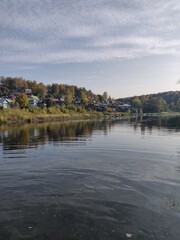 There is a boat that is floating in the water near a shore